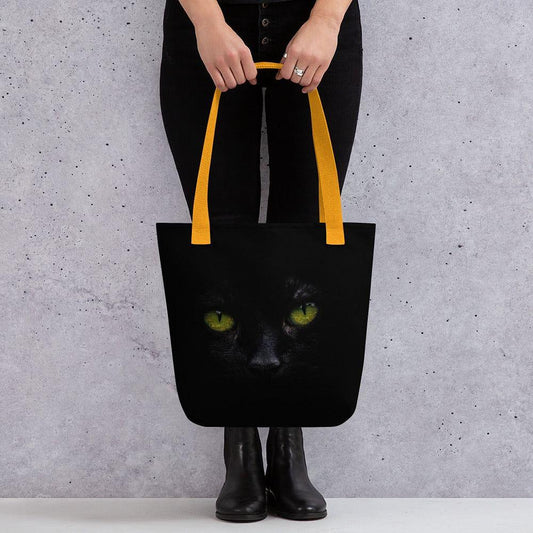 Black cat tote bag with green eyes design and red handles