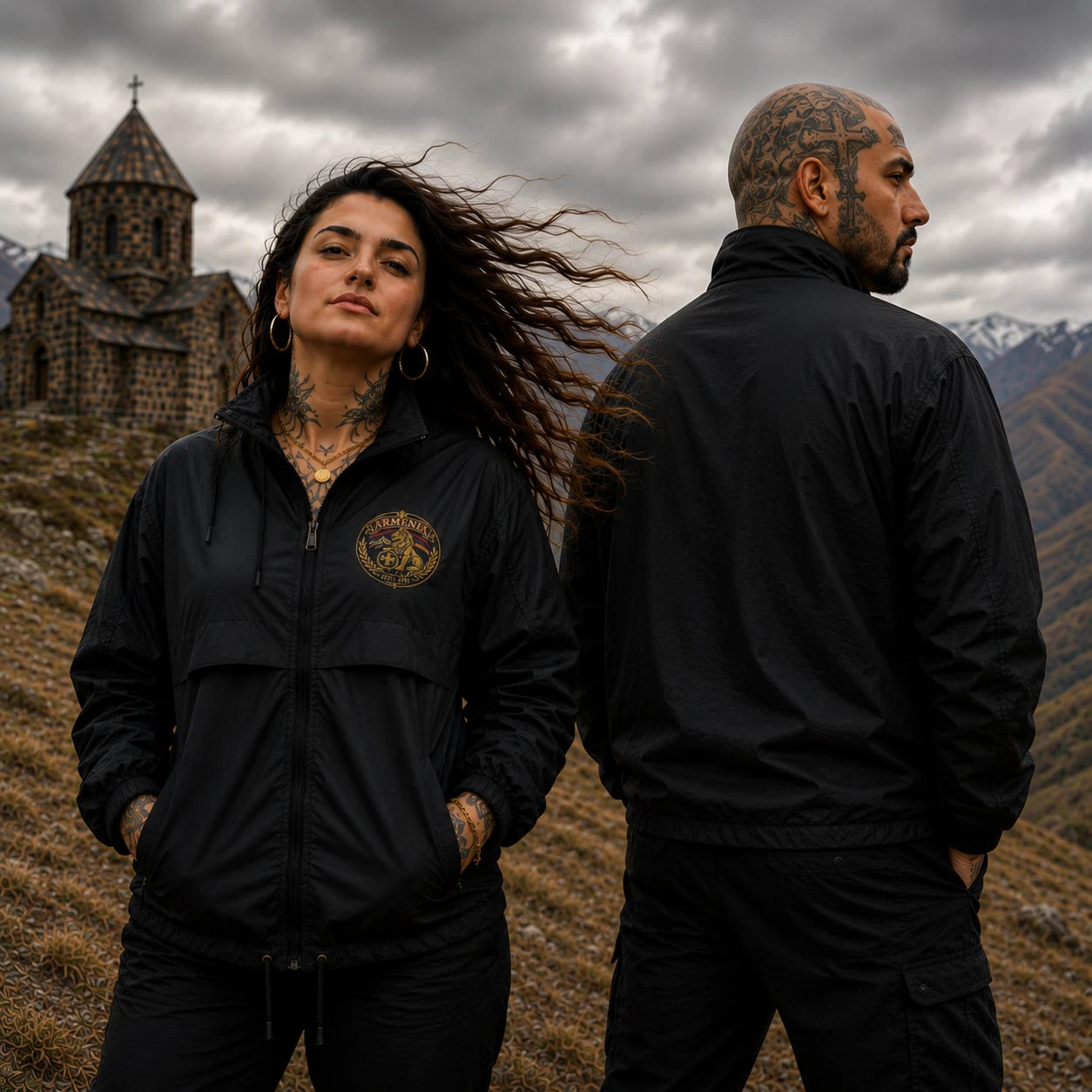 Armenian Pride black windbreaker worn by tattooed young couple showing front and back in dramatic mountain landscape
