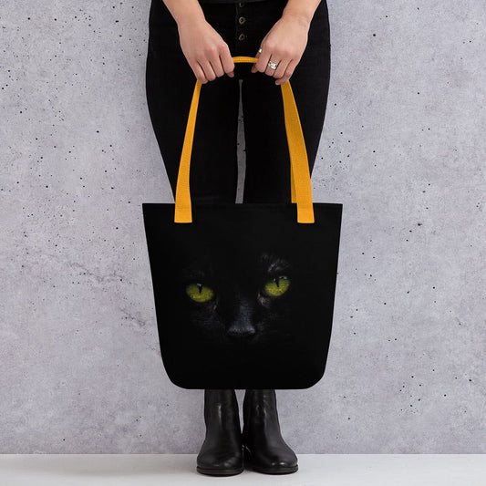 Black cat tote bag with green eyes design and red handles