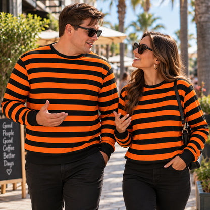Orange black sweatshirt on a man and woman in sunny outdoor setting