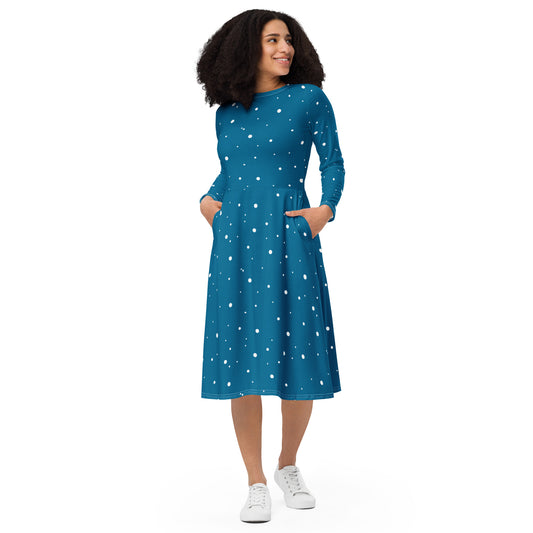 Woman wearing a blue white polka dot midi dress with long sleeves