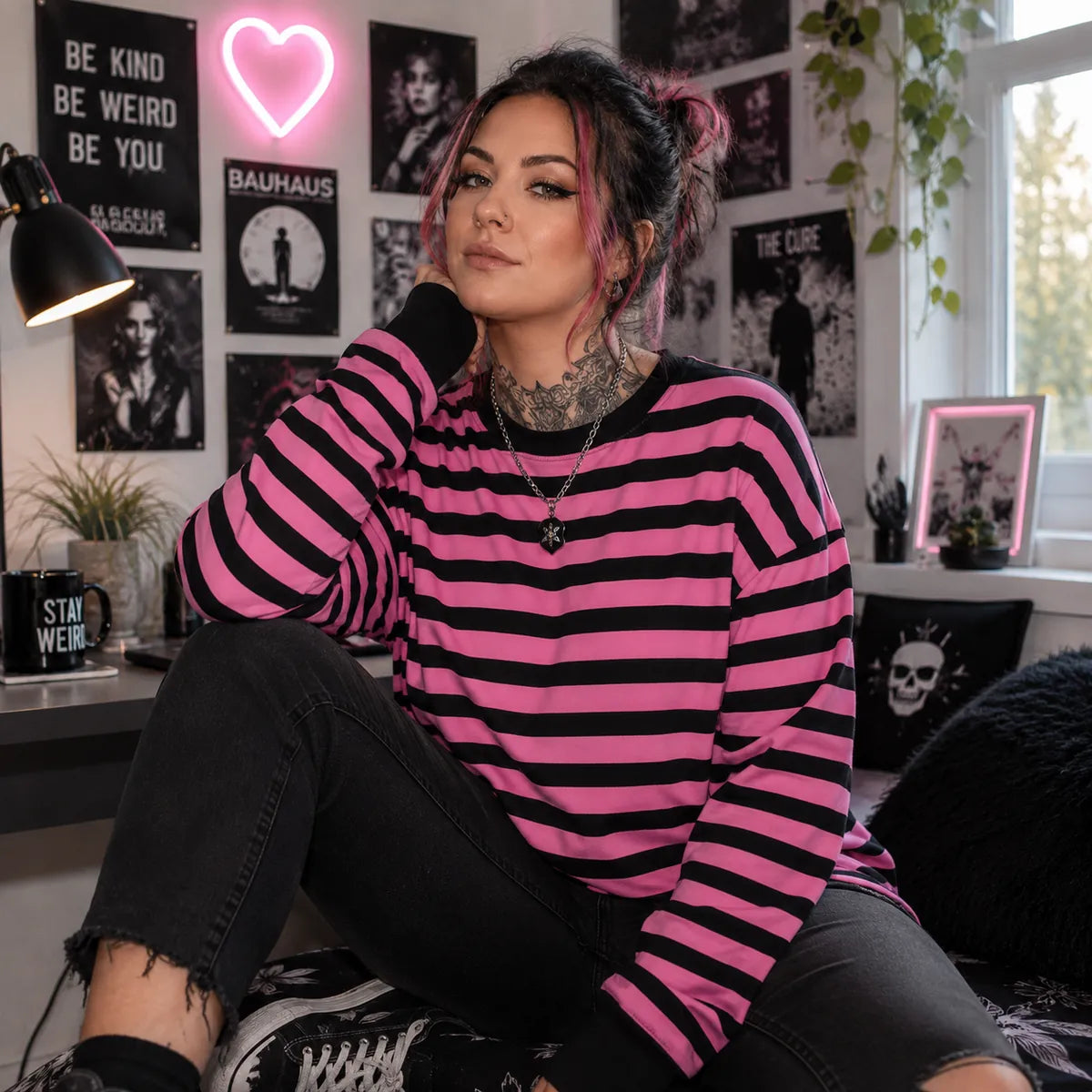Woman wearing a pink and black striped sweatshirt in alternative fashion style